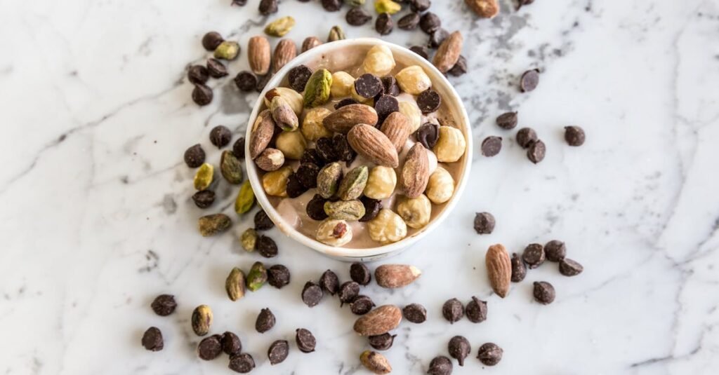 Boost Your Energy Naturally A bowl of mixed nuts and chocolate chips on a marble surface, perfect for healthy snacking. 